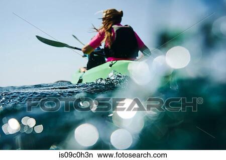 Teenage boy and mother sea kayaking, surface level rear view, Limnos, Khios, Greece View Large Photo Image Picture - Teenage boy and mother sea kayaking, surface level rear view, Limnos, Khios, Greece. Fotosearch