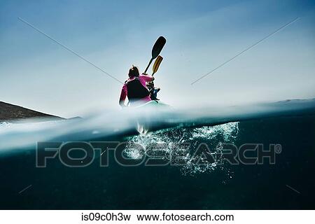 Teenage boy and mother sea kayaking, surface level rear view, Limnos, Khios, Greece View Large Photo Image Stock Photo - Teenage boy and mother sea kayaking, surface level rear view, Limnos, Khios, Greece. Fotosearch