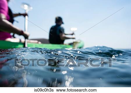 Teenage boy and mother sea kayaking, surface level shallow focus side view, Limnos, Khios, Greece View Large Photo Image Stock Photograph - Teenage boy and mother sea kayaking, surface level shallow focus side view, Limnos, Khios, Greece. Fotosearch