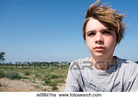 Teenage boy, flat countryside in background View Large Photo Image Stock Image - Teenage boy, flat countryside in background. Fotosearch