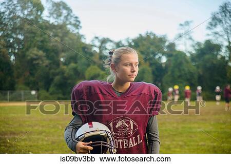 Stock Image - Teenage female football player on field. Fotosearch