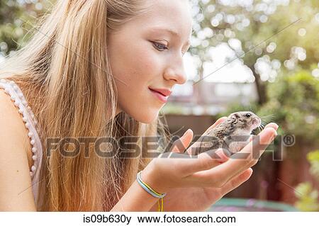 Teenage girl holding hamster View Large Photo Image Stock Photo - Teenage girl holding hamster. Fotosearch