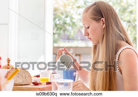 Stock Photography - Teenage girl preparing breakfast. Fotosearch