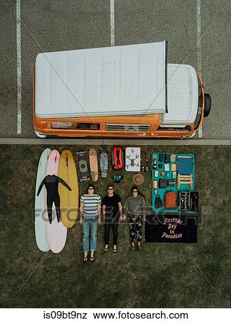 Three young surfers with surfing equipment and recreational vehicle lying on backs by beach carpark, overhead portrait, Ventura, California, USA View Large Photo Image Stock Photo - Three young surfers with surfing equipment and recreational vehicle lying on backs by beach carpark, overhead portrait, Ventura, California, USA. Fotosearch