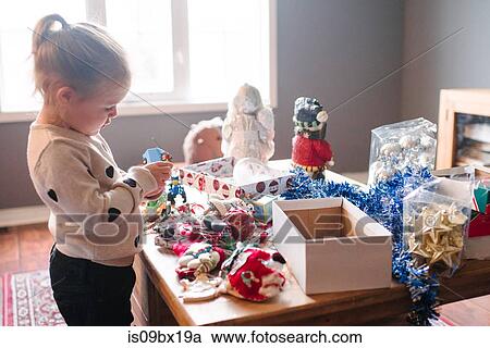 Stock Image - Toddler girl preparing for Christmas. Fotosearch