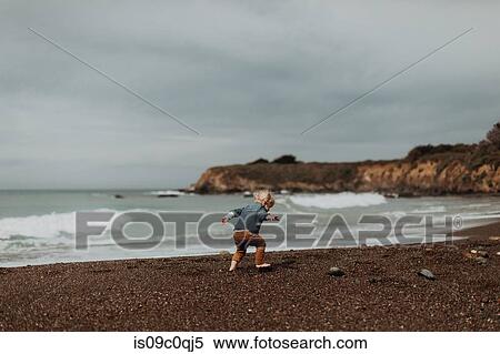 Stock Photography - Toddler playing on beach, Morro Bay, California, United States. Fotosearch