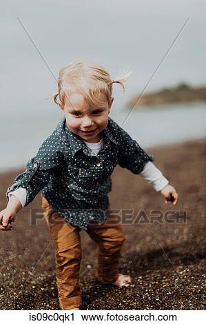Toddler playing on beach View Large Photo Image Stock Image - Toddler playing on beach. Fotosearch