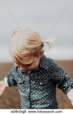 Toddler playing on beach View Large Photo Image Stock Photo - Toddler playing on beach. Fotosearch