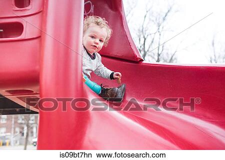 Picture - Toddler playing on slide. Fotosearch