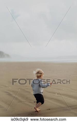 Toddler running on beach, Morro Bay, California, United States View Large Photo Image Stock Photo - Toddler running on beach, Morro Bay, California, United States. Fotosearch