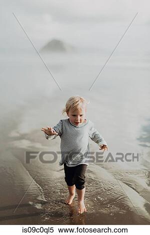 Stock Photography - Toddler walking on beach, Morro Bay, California, United States. Fotosearch
