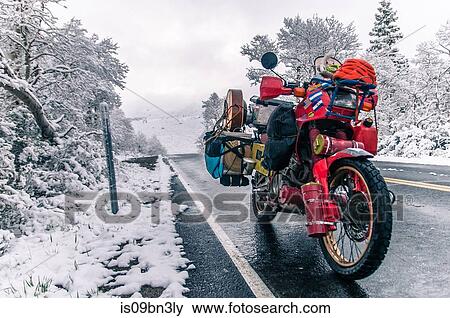Touring motorcycle parked on roadside in winter, Placerville, California, USA View Large Photo Image Stock Photo - Touring motorcycle parked on roadside in winter, Placerville, California, USA. Fotosearch