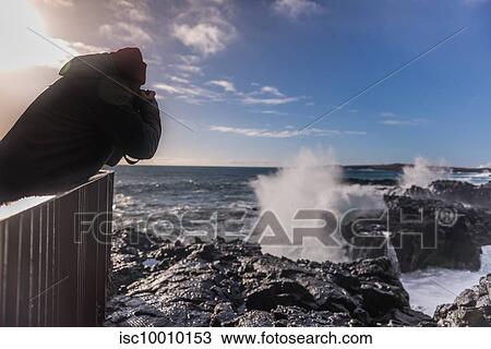 Tourist photographing ocean waves from pier, Reykjanes, Iceland View Large Photo Image Stock Image - Tourist photographing ocean waves from pier, Reykjanes, Iceland. Fotosearch