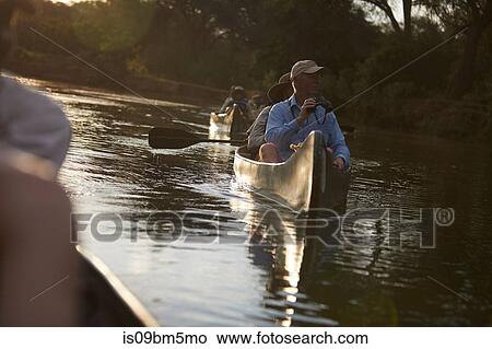 Tourists canoeing on safari, Zambezi, Zambia View Large Photo Image Picture - Tourists canoeing on safari, Zambezi, Zambia. Fotosearch