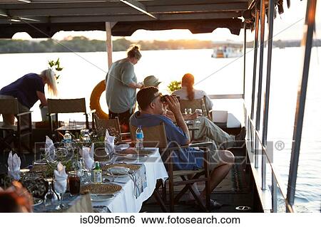 Tourists on river cruise, Victoria Falls, Zimbabwe View Large Photo Image Stock Photograph - Tourists on river cruise, Victoria Falls, Zimbabwe. Fotosearch