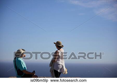 Stock Photography - Tourists pointing and looking into distance, Cape Town, Western Cape, South Africa. Fotosearch