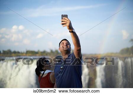 Tourists taking selfie, Victoria Falls, Zimbabwe View Large Photo Image Stock Image - Tourists taking selfie, Victoria Falls, Zimbabwe. Fotosearch