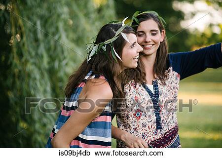 Twin sisters beside weeping willow branches View Large Photo Image Stock Image - Twin sisters beside weeping willow branches. Fotosearch