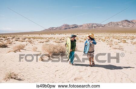 Two boys walking together Eureka Dunes, Death Valley National Park, California, USA View Large Photo Image Stock Photo - Two boys walking together Eureka Dunes, Death Valley National Park, California, USA. Fotosearch