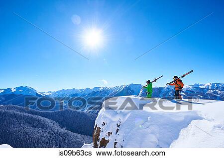Two male skiers looking out from snow covered ridge, Aspen, Colorado, USA View Large Photo Image Stock Photograph - Two male skiers looking out from snow covered ridge, Aspen, Colorado, USA. Fotosearch