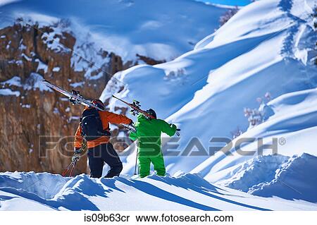 Two male skiers trudging up deep snow covered mountain, Aspen, Colorado, USA View Large Photo Image Stock Photography - Two male skiers trudging up deep snow covered mountain, Aspen, Colorado, USA. Fotosearch