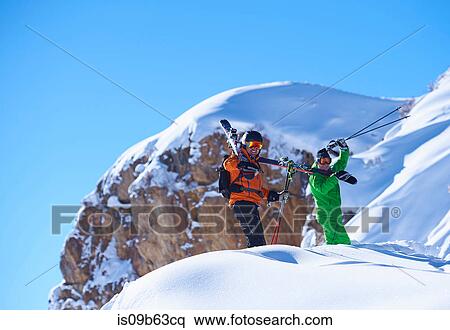 Two male skiers trudging up snow covered ridge, Aspen, Colorado, USA View Large Photo Image Stock Photography - Two male skiers trudging up snow covered ridge, Aspen, Colorado, USA. Fotosearch