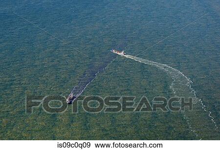 Stock Photo - Two ships passing each other early morning at sea. Fotosearch