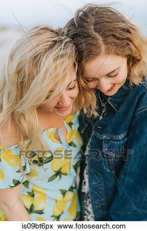 Two young women hugging on beach, close up, Menemsha, Martha's Vineyard, Massachusetts, USA View Large Photo Image Stock Photo - Two young women hugging on beach, close up, Menemsha, Martha's Vineyard, Massachusetts, USA. Fotosearch