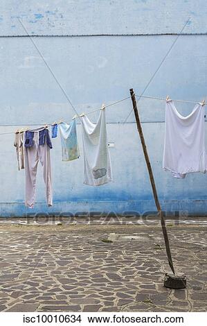 Picture - Washed clothes on clothesline in residential backyard with flagstones, Burano Island, Venetian Lagoon, Venice, Veneto, Italy. Fotosearch