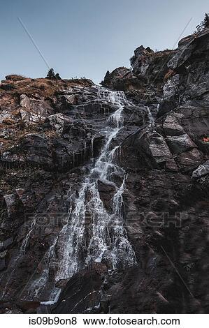 Stock Photo - Waterfall moving down over rockface, Draja, Vaslui, Romania. Fotosearch