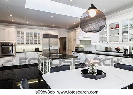 White breakfast table with black leather chairs, white wood and glass pane island with black granite countertop, cupboards in country style kitchen, black granite tile flooring View Large Photo Image Stock Image - White breakfast table with black leather chairs, white wood and glass pane island with black granite countertop, cupboards in country style kitchen, black granite tile flooring. Fotosearch