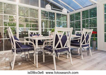 White dining table and armchairs with blue cushions in sunroom View Large Photo Image Stock Photograph - White dining table and armchairs with blue cushions in sunroom. Fotosearch