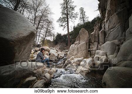 Woman and dog sitting by river, Lake Arrowhead, California, USA View Large Photo Image Stock Image - Woman and dog sitting by river, Lake Arrowhead, California, USA. Fotosearch
