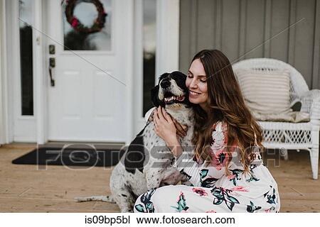 Woman and her dog sitting on porch View Large Photo Image Stock Image - Woman and her dog sitting on porch. Fotosearch