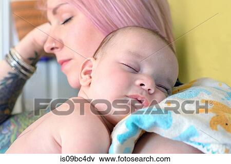 Stock Photo - Woman asleep with sleeping baby boy on shoulder. Fotosearch