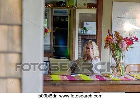Woman at desk using laptop computer View Large Photo Image Stock Photography - Woman at desk using laptop computer. Fotosearch