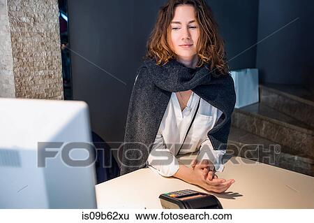 Woman at payment counter View Large Photo Image Stock Photograph - Woman at payment counter. Fotosearch
