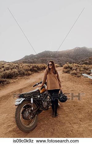 Woman beside motorbike, Kennedy Meadows, California, US View Large Photo Image Stock Photo - Woman beside motorbike, Kennedy Meadows, California, US. Fotosearch