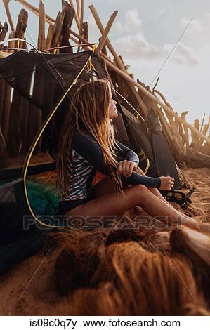 Stock Photo - Woman camping on sandy beach, Princeville, Hawaii, US. Fotosearch