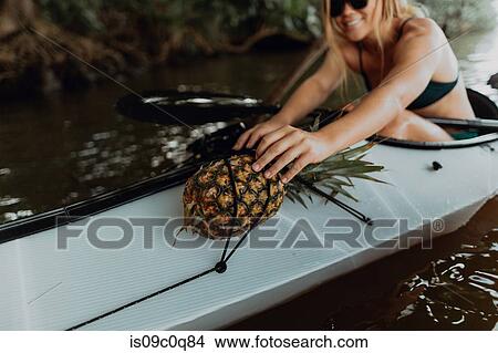 Woman carrying pineapple on kayak, Princeville, Hawaii, US View Large Photo Image Picture - Woman carrying pineapple on kayak, Princeville, Hawaii, US. Fotosearch