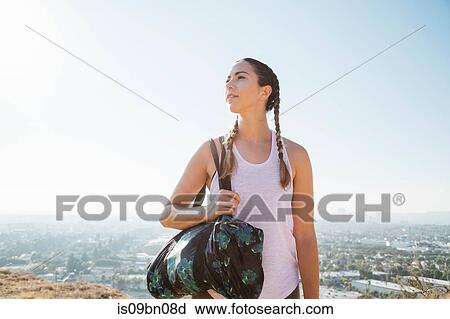 Woman carrying sports bag on hilltop, Los Angeles, US View Large Photo Image Stock Image - Woman carrying sports bag on hilltop, Los Angeles, US. Fotosearch