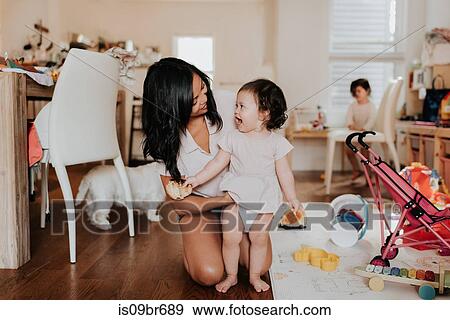 Woman changing clothes on toddler daughter View Large Photo Image Stock Photo - Woman changing clothes on toddler daughter. Fotosearch