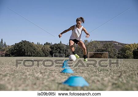 Woman dribbling football View Large Photo Image Stock Image - Woman dribbling football. Fotosearch