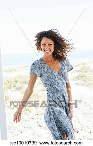 Woman enjoying breeze by beach View Large Photo Image Stock Photo - Woman enjoying breeze by beach. Fotosearch