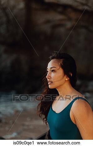 Stock Image - Woman enjoying breeze on beach, Big Sur, California, United States. Fotosearch