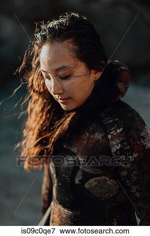 Stock Photo - Woman enjoying breeze on beach. Fotosearch