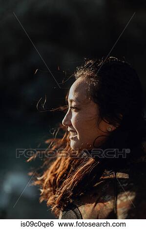 Woman enjoying breeze on beach View Large Photo Image Stock Photograph - Woman enjoying breeze on beach. Fotosearch