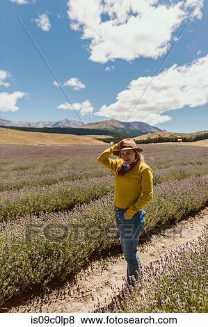 Stock Photo - Woman enjoying meadow, Wanaka, Taranaki, New Zealand. Fotosearch