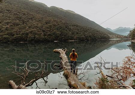 Stock Photo - Woman enjoying scenic lake view, Queenstown, Canterbury, New Zealand. Fotosearch