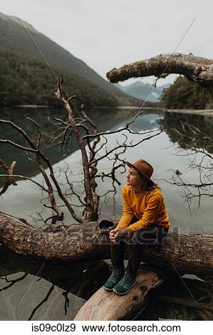 Stock Photo - Woman enjoying scenic lake view, Queenstown, Canterbury, New Zealand. Fotosearch